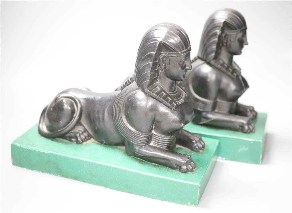 A pair of Egyptianesque composition bookends, each modelled as a Sphinx, width 28cm height 23cm